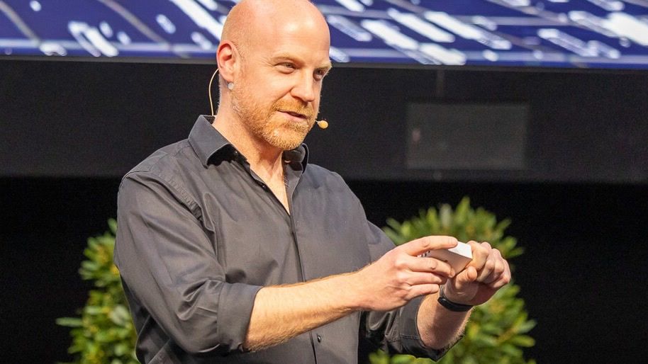 Richard Seidl keynote on AI and empathy on stage, intense presentation scene